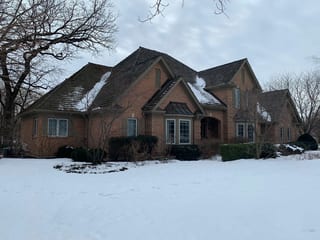 Before: a worn out wood shake roof on the home, Crystal Lake, Illinois, ahead of a Deep Charcoal Interlock Slate aluminum roof