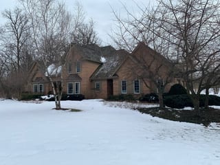 Before: a worn out wood shake roof on the home, Crystal Lake, Illinois, ahead of a Deep Charcoal Interlock Slate aluminum roof