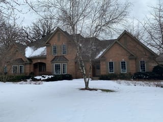 Before: a worn out wood shake roof on the home, Crystal Lake, Illinois, ahead of a Deep Charcoal Interlock Slate aluminum roof