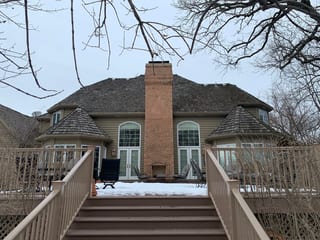 Before: a worn out wood shake roof on the home, Crystal Lake, Illinois, ahead of a Deep Charcoal Interlock Slate aluminum roof