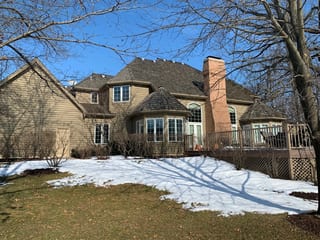 Before: a worn out wood shake roof on the home, Crystal Lake, Illinois, ahead of a Deep Charcoal Interlock Slate aluminum roof