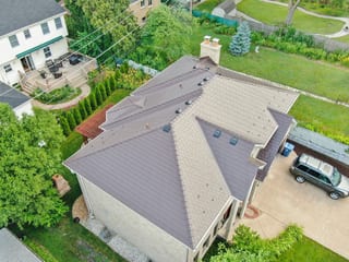 Colonial Brown Interlock Slate aluminum roof on a colonial style home with a brown metal roof in a suburban, Calredon Hills, Illinois