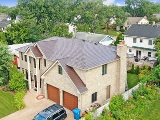 Colonial Brown Interlock Slate aluminum roof on a Colonial brown two-storey home with a metal roof in a, Calredon Hills, Illinois