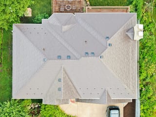 Colonial Brown Interlock Slate aluminum roof on a brown colonial home with a metal roof in a wooded, Calredon Hills, Illinois