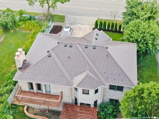 Colonial Brown Interlock Slate aluminum roof on a Colonial brown metal roof on a two-storey white home, Calredon Hills, Illinois