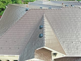 Colonial Brown Interlock Slate aluminum roof on a Colonial home with dormers and brown roof in the Calredon, Calredon Hills, Illinois