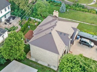 Colonial Brown Interlock Slate aluminum roof on a Colonial brown metal roof on a single-family home in a, Calredon Hills, Illinois