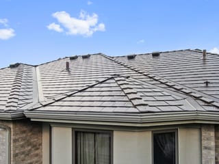 Colonial Brown Interlock Slate aluminum roof on a tan colonial home with a brown roof in a suburban setting, Calredon Hills, Illinois