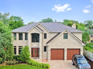 Colonial Brown Interlock Slate aluminum roof on a Colonial style home with a metal roof in a wooded area, Calredon Hills, Illinois
