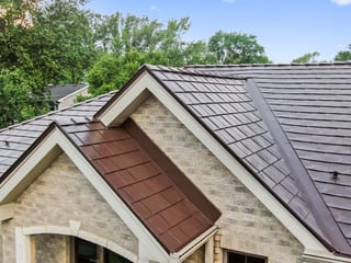 Colonial Brown Interlock Slate aluminum roof on a colonial style home with dormers in a forested suburban, Calredon Hills, Illinois