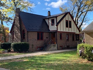 Tudor Brown Interlock Slate aluminum roof on a Tudor brown metal roof on a brick house in a suburban, Elmhurst, Illinois