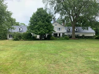 Black Interlock Standing Seam aluminum roof on a large colonial home with a grey metal roof and dormers, Lake Forest, Illinois