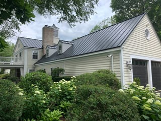 Black Interlock Standing Seam aluminum roof on a colonial home with a black metal roof, surrounded by, Lake Forest, Illinois