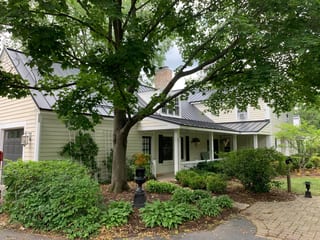 Black Interlock Standing Seam aluminum roof on a colonial home with a black metal roof, surrounded by, Lake Forest, Illinois