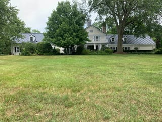 Black Interlock Standing Seam aluminum roof on a colonial home with a black metal roof in a forested, Lake Forest, Illinois