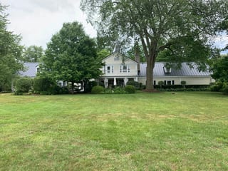 Black Interlock Standing Seam aluminum roof on a colonial home with a metal roof on a forested rural, Lake Forest, Illinois