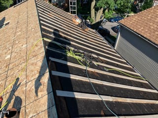 Black Interlock Slate aluminum roof being installed on the home, replacing a worn out asphalt shingle roof, Oak Park, Illinois