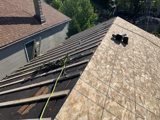 Black Interlock Slate aluminum roof being installed on the home, replacing a worn out asphalt shingle roof, Oak Park, Illinois
