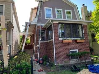 Black Interlock Slate aluminum roof being installed on the home, replacing a worn out asphalt shingle roof, Oak Park, Illinois