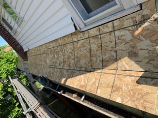 Black Interlock Slate aluminum roof being installed on the home, replacing a worn out asphalt shingle roof, Oak Park, Illinois