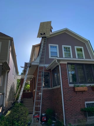 Black Interlock Slate aluminum roof being installed on the home, replacing a worn out asphalt shingle roof, Oak Park, Illinois