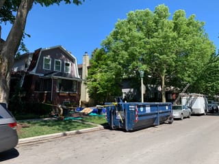 Black Interlock Slate aluminum roof being installed on a two-storey home with dormers in a suburban neighbourhood, Oak Park, Illinois