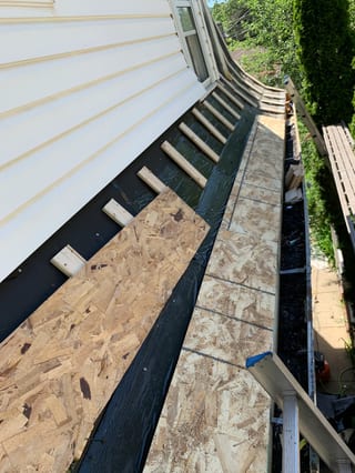Black Interlock Slate aluminum roof being installed on the home, replacing a worn out asphalt shingle roof, Oak Park, Illinois