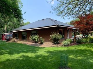 Black Interlock Slate aluminum roof on a brown single-family home with a metal roof and brick, Flossmoor, Illinois