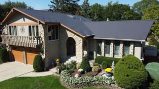 Tudor Brown Interlock Cedar Shingle aluminum roof on a Tudor Brown metal roof on a single-storey home with stone, Bartlett, Illinois