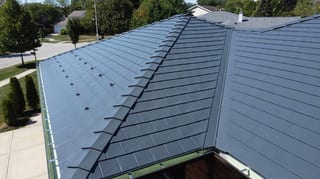 Deep Charcoal Interlock Slate aluminum roof on a large two-storey home with a metal roof in a suburban, Westmont, Illinois