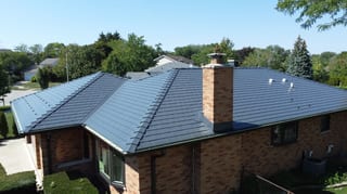 Deep Charcoal Interlock Slate aluminum roof on a red brick ranch home with a metal roof in a suburban, Westmont, Illinois