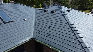 Deep Charcoal Interlock Slate aluminum roof on a deep charcoal metal roof on a suburban home with lush, Westmont, Illinois
