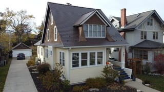 Aerial view of a Craftsman-style home in La Grange, IL featuring Interlock Colonial Brown cedar shingle aluminum roofing with multiple dormers and complex roofline.