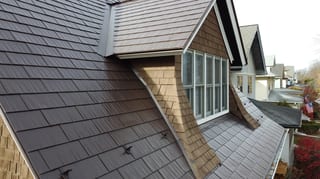 Colonial Brown Interlock Cedar Shingle aluminum roof on a colonial-style home with a metal roof among fall foliage, La Grange, Illinois