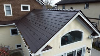 Colonial Brown Interlock Cedar Shingle aluminum roof on a cream two-storey home with dormers in a rural suburban, La Grange, Illinois
