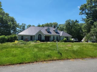 Tudor Brown Interlock Cedar Shingle aluminum roof on a Tudor Brown metal roof on a colonial home in a rural, East Taunton, Massachusetts