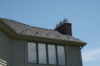 Weathered Interlock Shake aluminum roof on a tan single-family ranch home with a metal roof in a rural, Mendota Heights, Minnesota