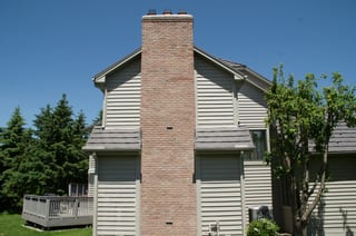 Weathered Interlock Shake aluminum roof on a white home with a metal roof and a tree in a suburban, Mendota Heights, Minnesota