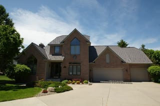 Weathered Interlock Shake aluminum roof on a brick home with a garage and two stories in a suburban, Mendota Heights, Minnesota