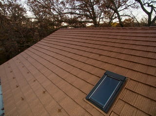 Aged Copper Interlock Shake aluminum roof on a two-storey home with an aged copper metal roof among tall, Bloomington, Minnesota
