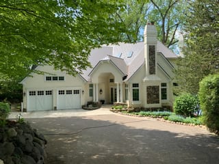 Weathered Interlock Cedar Shingle aluminum roof on a white single-family home with a metal roof in a wooded, Shorewood, Minnesota