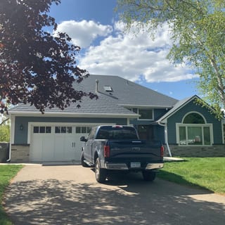 Deep Charcoal Interlock Slate aluminum roof on a two-storey home with dormers in a suburban setting, Eden Prairie, Minnesota
