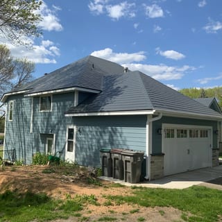 Deep Charcoal Interlock Slate aluminum roof on a blue two-storey home with a gable roof and attached, Eden Prairie, Minnesota