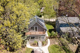 Deep Charcoal Interlock Slate aluminum roof on a two-storey home with a metal roof in a forested suburb, Minneapolis, Minnesota