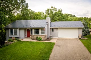 Deep Charcoal Interlock Slate aluminum roof on a grey ranch home with a metal roof in a wooded suburban, Red Wing, Minnesota