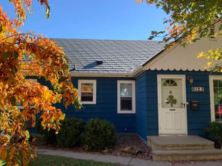 Deep Charcoal Interlock Slate aluminum roof on a Deep Charcoal two-storey home with dormers among tall, Minneapolis, Minnesota
