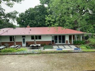 Tile Red Interlock Slate aluminum roof on a red roofed ranch style home surrounded by trees, Edina, Minnesota