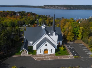Deep Charcoal Interlock Slate aluminum roof on a white church among autumn trees near a lake, Rothesay, New Brunswick