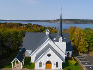Deep Charcoal Interlock Slate aluminum roof on a white church with a slate metal roof overlooking a body, Rothesay, New Brunswick