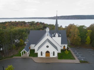 Deep Charcoal Interlock Slate aluminum roof on a white church with a grey metal roof near a body of water, Rothesay, New Brunswick